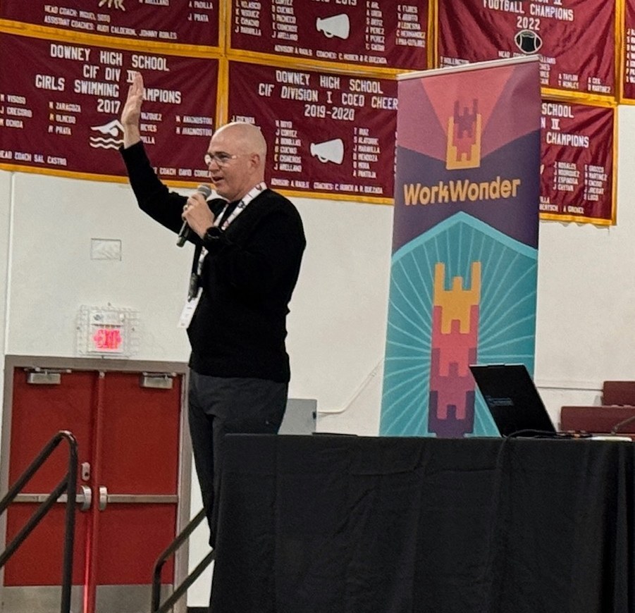 Harlen Bayha speaking on stage at a WorkWonder event